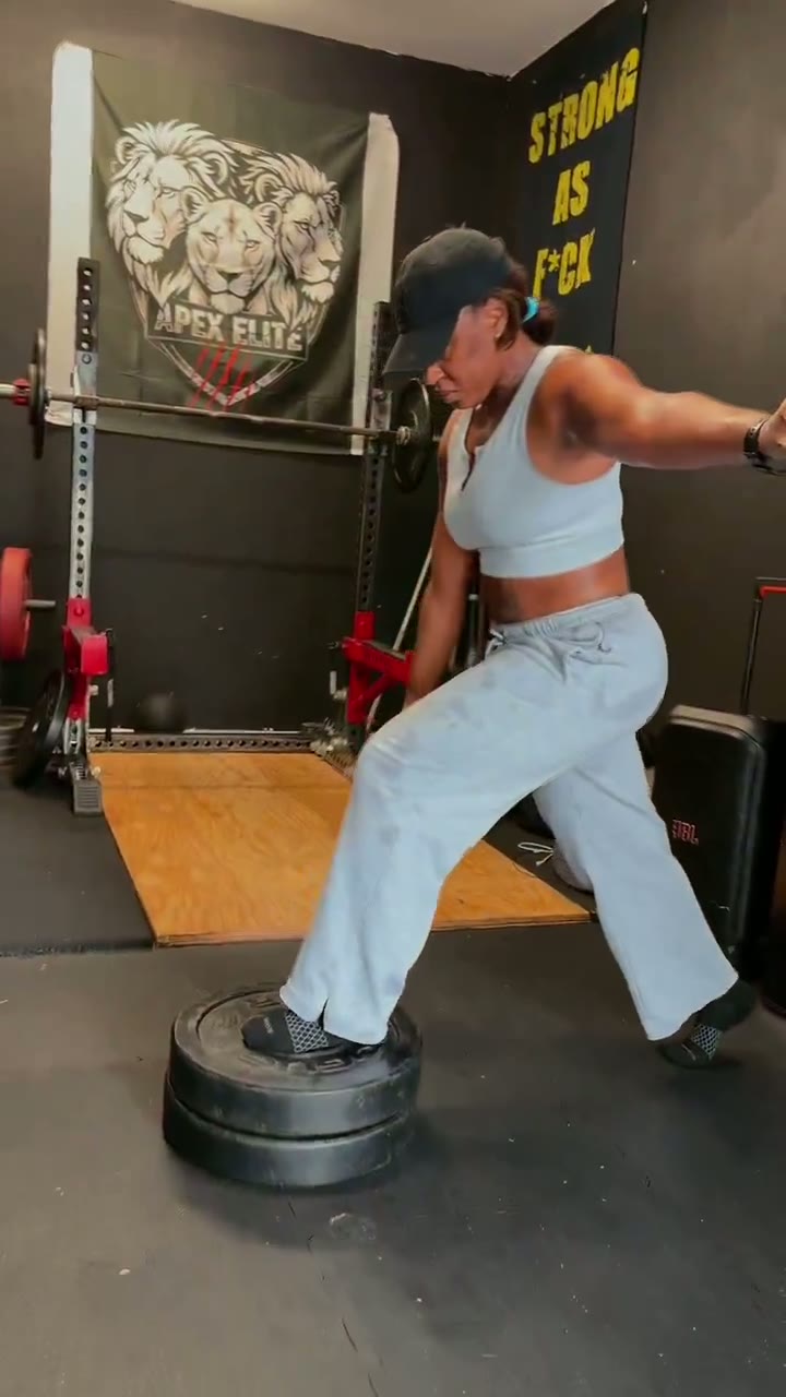 Coach Mac coaching a client through squats, lunges and glute bridges in the Apollo Beach training space