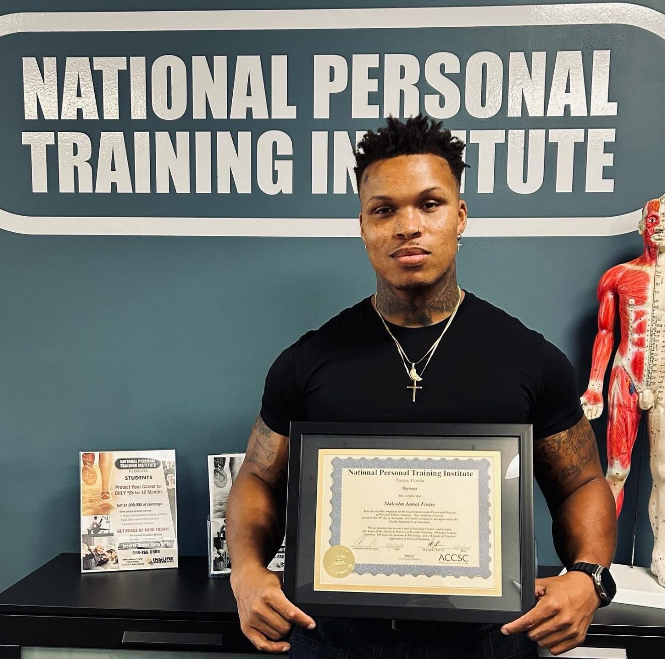 Mac Jamal Foster holding his diploma from the National Personal Training Institute of Florida